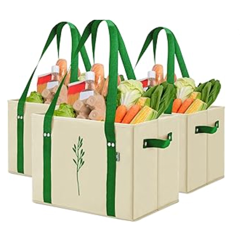 Three reusable grocery bags with green handles and a plant design on the side. Each bag is filled with groceries, including bottles and fresh vegetables like lettuce, carrots, and corn.