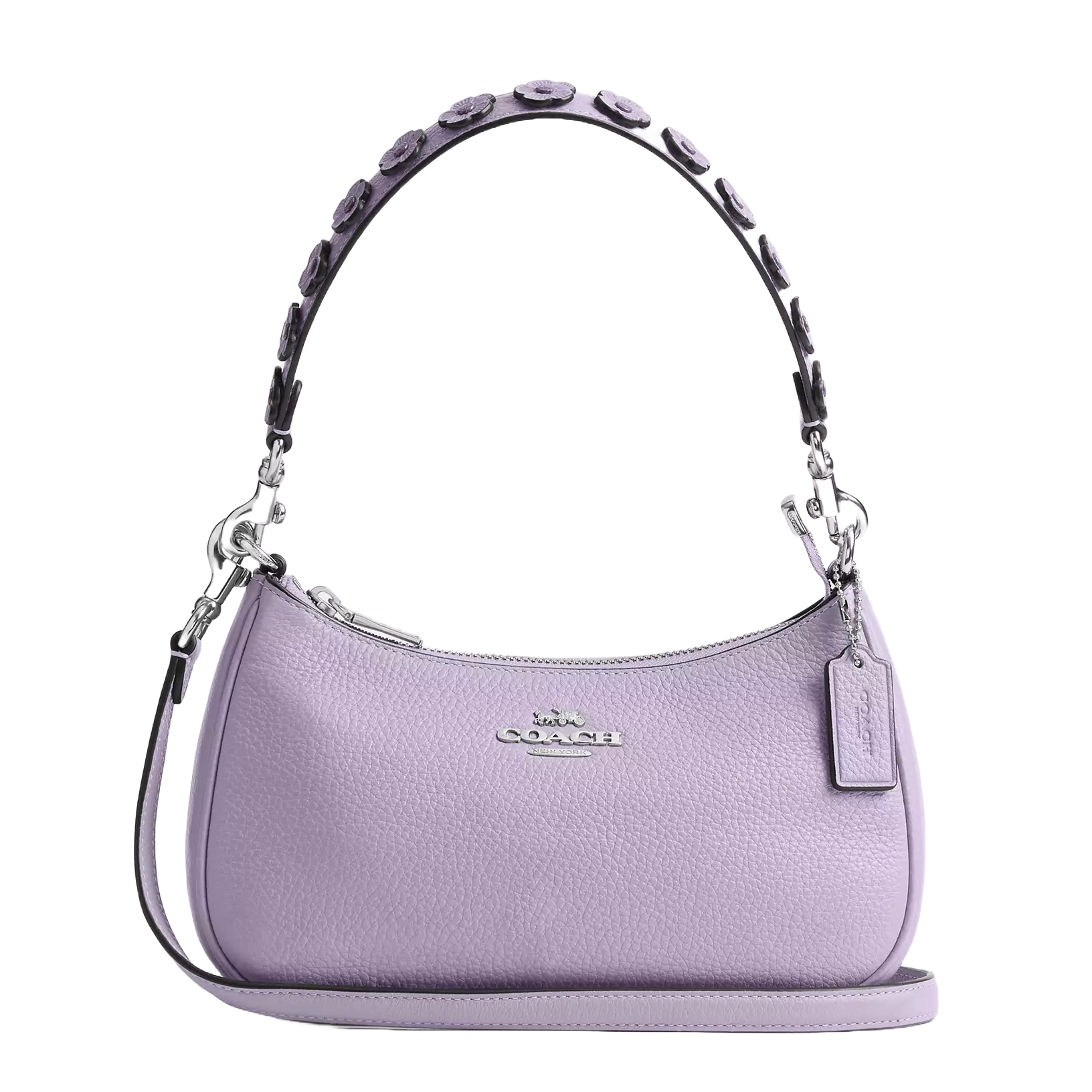 A lavender pebbled leather shoulder bag with floral appliques on the handle, featuring silver-tone hardware, a detachable strap, and a Coach logo tag.