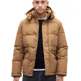 A person is wearing a tan puffer jacket with a hood, black shirt, and dark jeans.