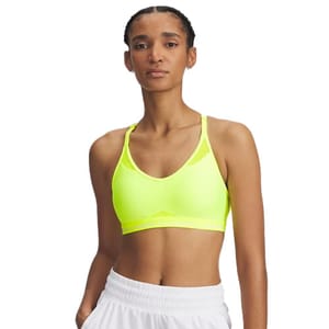 A person wearing a bright yellow sports bra and white shorts. The sports bra has a racerback design.