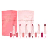 Tarte Maracuja Juicy Lip Sculptors 6-piece set includes dual-ended lip products with lipsticks and matching glosses, featuring a range of colors from pinks to reds. Each item is presented with pink and rose-colored packaging.