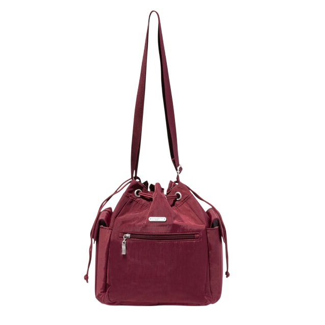 A maroon drawstring shoulder bag with external zip pocket and side pockets, featuring a long adjustable strap and metal hardware accents.