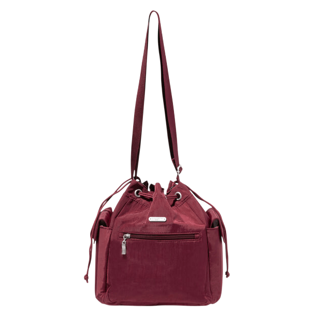 A maroon drawstring shoulder bag with external zip pocket and side pockets, featuring a long adjustable strap and metal hardware accents.
