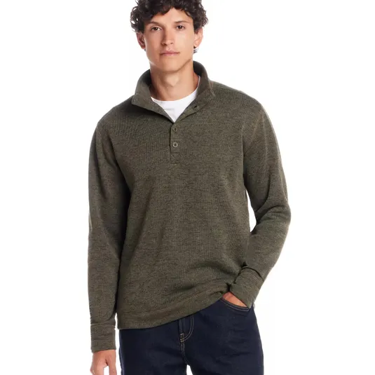 A man wears a long-sleeve, olive green henley pullover paired with dark jeans, featuring a button-up collar design.