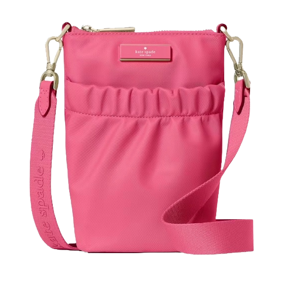 A pink crossbody bag with a zip closure and adjustable strap, featuring the Kate Spade logo on the front.