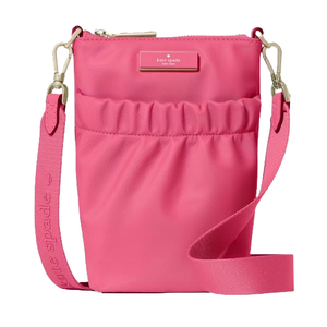 A pink crossbody bag with a zip closure and adjustable strap, featuring the Kate Spade logo on the front.