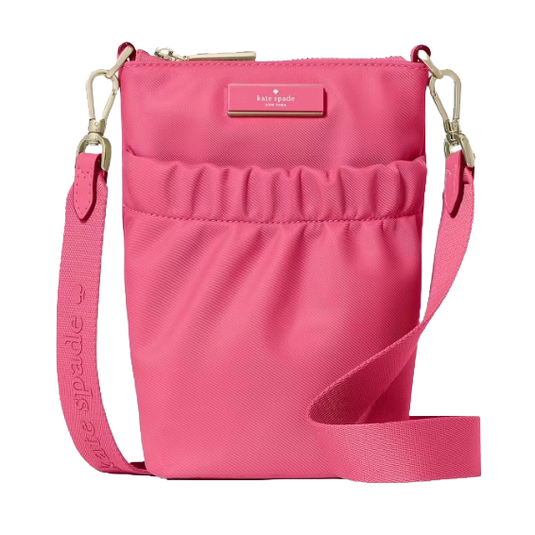 A pink crossbody bag with a zip closure and adjustable strap, featuring the Kate Spade logo on the front.