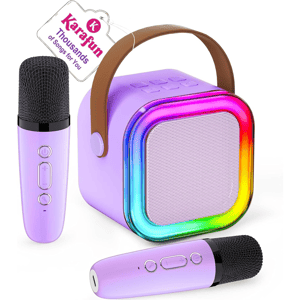 A purple karaoke speaker with a rainbow LED ring and a leather handle is accompanied by two matching purple microphones. A tag mentions \“Karafun\“ with \“Thousands of Songs for You.\“