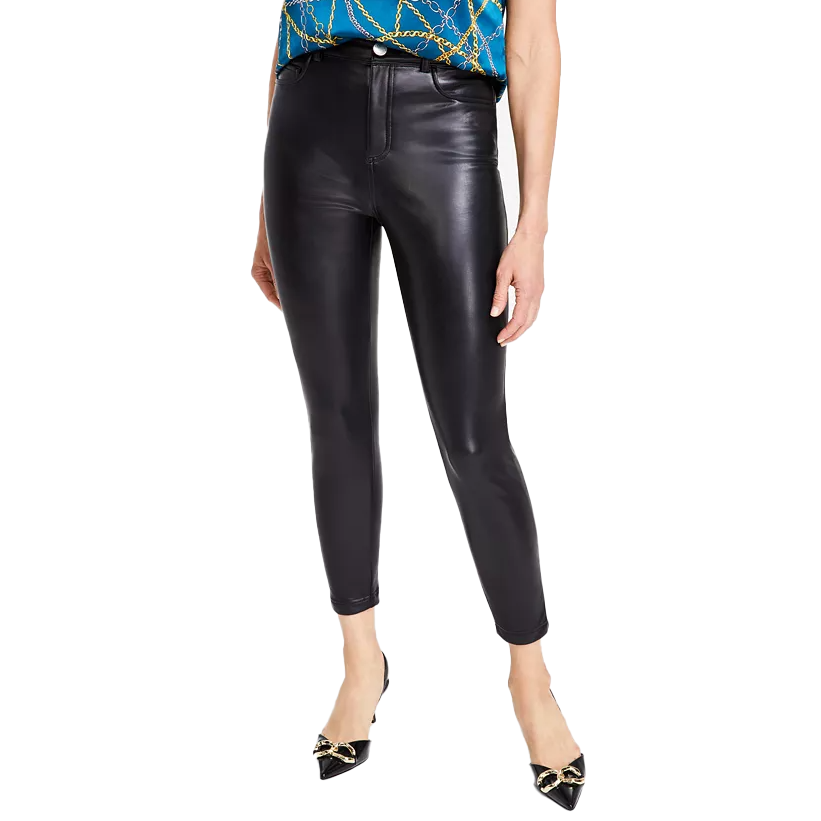 Black faux-leather skinny pants with a high waist and a sleek, fitted silhouette. Paired with pointed black heels featuring gold embellishments.