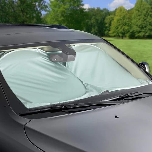 A car windshield sun shade installed on a vehicle to block sunlight.