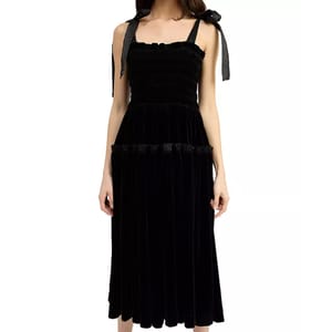 Black velvet midi dress with a smocked bodice and tie-shoulder straps. The dress features a fitted bodice and a semi-full skirt with a tiered design.