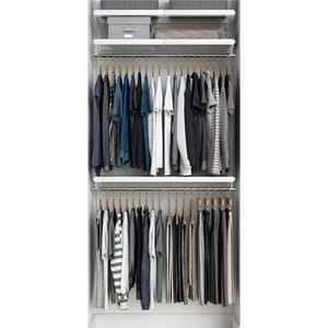 A neatly organized closet with two tiers of hanging clothes in neutral colors. The top shelf holds storage bins and boxes for additional organization.