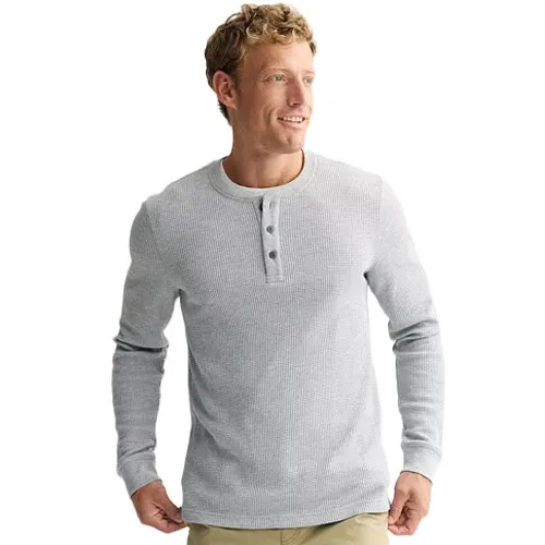 A man is wearing a light gray long-sleeve waffle-knit henley shirt with three buttons.