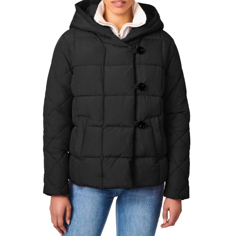A black quilted hooded jacket with button closure, worn over a white sweater and paired with blue jeans.