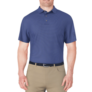 A man is wearing a blue patterned polo shirt with a collar and buttons, paired with beige pants and a black belt.