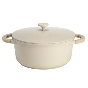 4.5qt Ceramic Dutch Oven with a sleek, minimalist design in an off-white color featuring integrated side handles and a matching lid with a round knob handle.