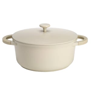 4.5qt Ceramic Dutch Oven with a sleek, minimalist design in an off-white color featuring integrated side handles and a matching lid with a round knob handle.