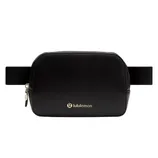 A black Lululemon belt bag with a gold zipper and logo, featuring a wide, adjustable strap.