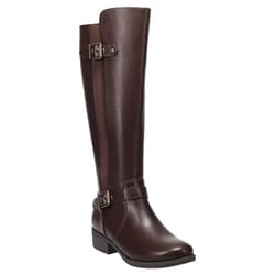 A tall, brown leather riding boot with buckles at the ankle and calf, featuring a low heel suitable for casual or equestrian wear.