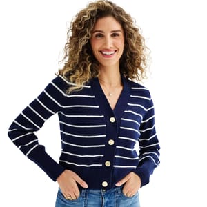 Blue and white striped cardigan with gold buttons, featuring a V-neck and ribbed cuffs. Worn over jeans, it offers a casual yet polished look.