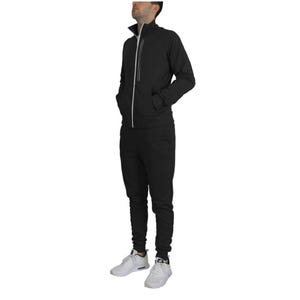A black men's tracksuit with a front zip jacket, featuring white trim and pockets. The pants are slim-fit and paired with white athletic shoes.