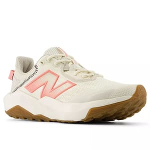 A New Balance running shoe with a cream and pink color scheme, featuring a mesh upper, gum sole, and distinctive branding.
