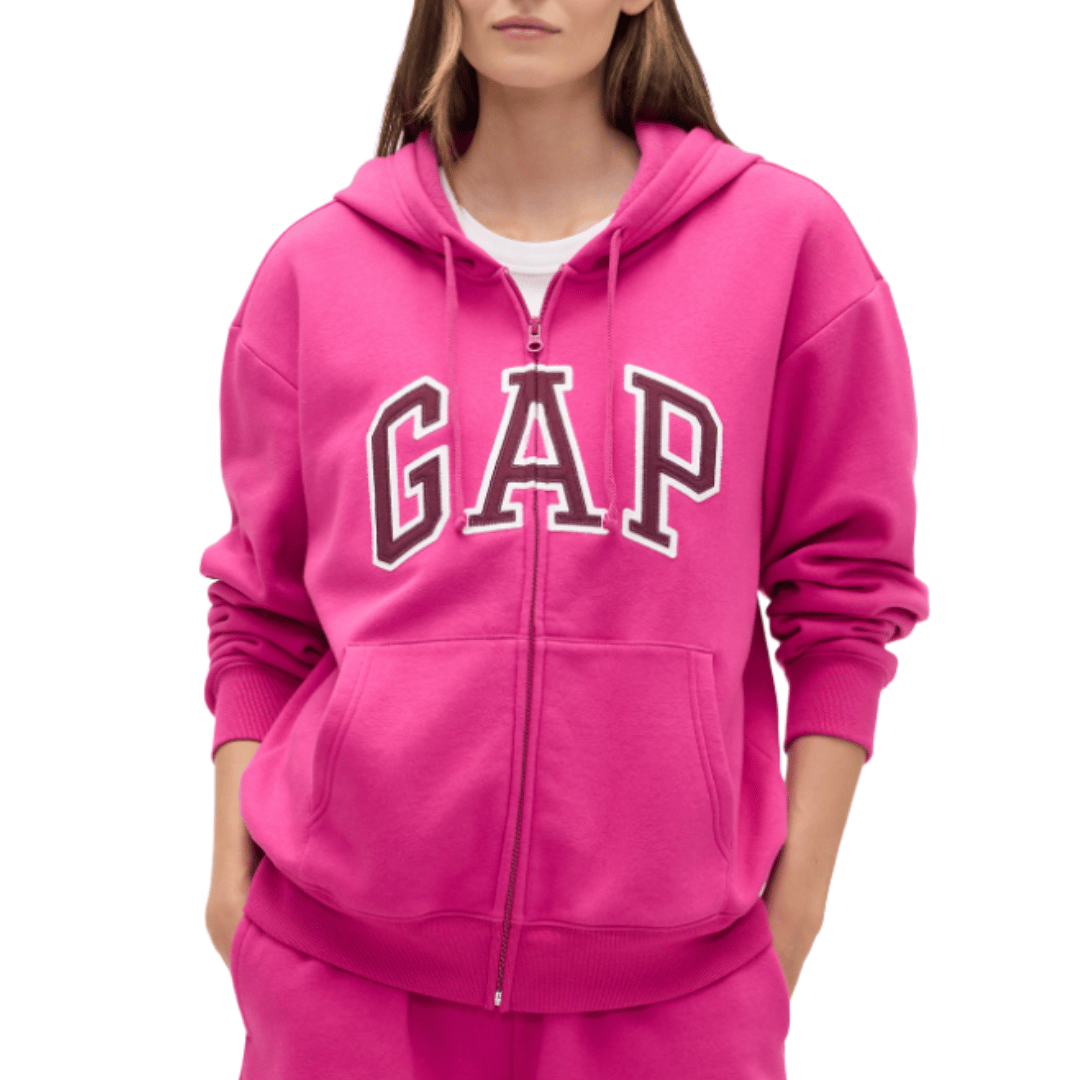 A person is wearing a bright pink GAP hoodie with a full zipper and front pockets.