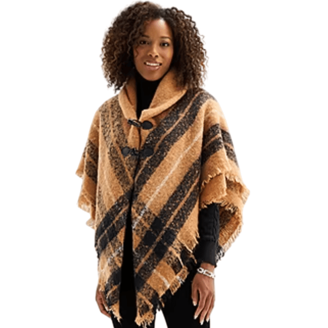 A woman is wearing a plaid shawl with a tan and black pattern, fastened with toggle closures over a black long-sleeve top.