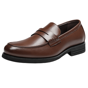 A brown leather loafer with a black sole, featuring a sleek design and a decorative strap across the top.