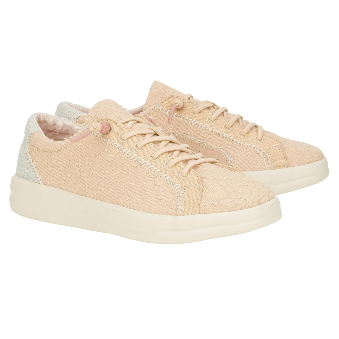 A pair of light pink casual sneakers with laces and a textured design.
