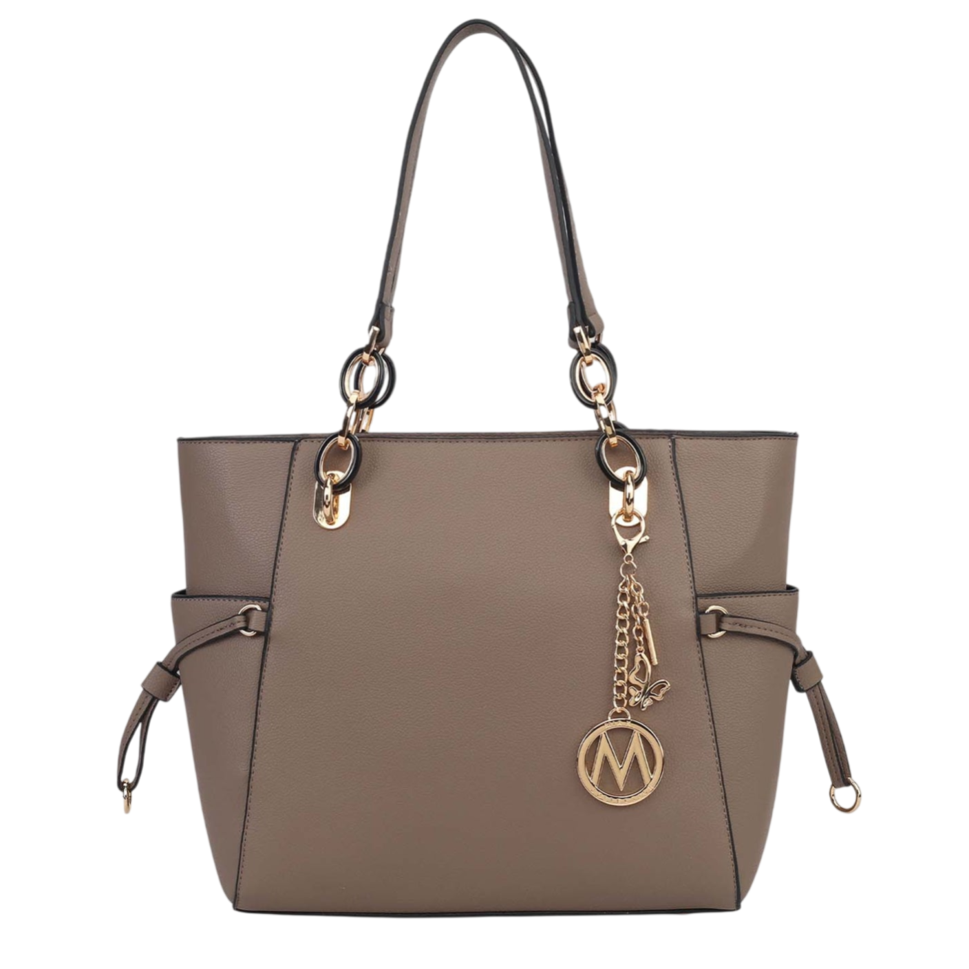 A taupe-colored tote bag featuring dual shoulder straps, gold hardware, and a decorative charm with an \“M\“ motif, accented with black piping.