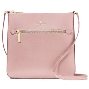 A pink leather crossbody bag with a front zip pocket and gold-tone hardware.