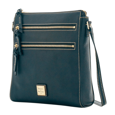 A dark blue crossbody bag featuring two front zippered pockets with tassel accents and a gold-tone metal logo plate at the bottom.