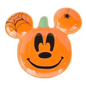 An orange, pumpkin-themed plate shaped like a well-known cartoon character's head, featuring a spider web and spider on the ears.