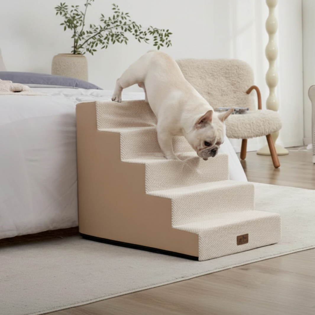 A dog is using a carpeted pet stair next to a bed in a cozy, well-furnished bedroom.