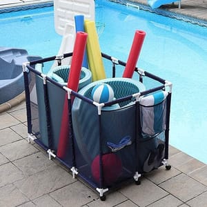 A portable storage bin for pool accessories is shown by a poolside, containing pool noodles, floats, balls, and towels. The structure features mesh sides and a PVC frame for easy organization and drainage.