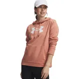 A woman is wearing an Under Armour hoodie in a peach color with a white cap and black leggings. The hoodie has a large front pocket and features the brand's logo on the chest.