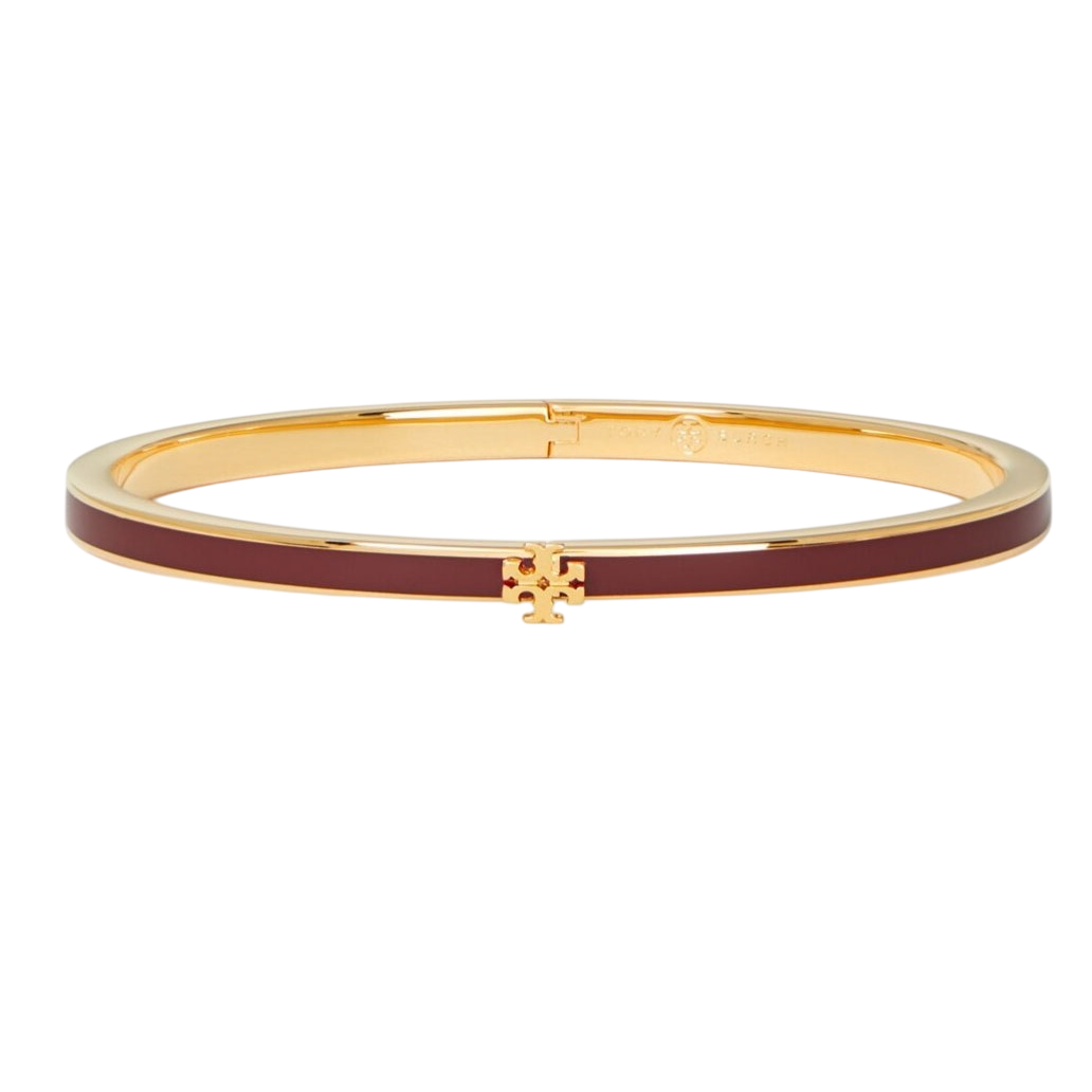 Gold-toned bangle bracelet with a maroon enamel inlay and a small decorative emblem at the center.