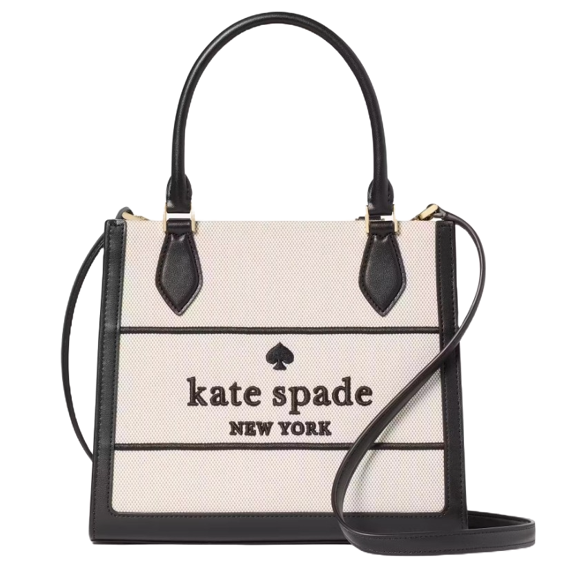 Kate Spade New York handbag with black leather handles and trim, featuring a spade logo and brand name on a beige canvas body.