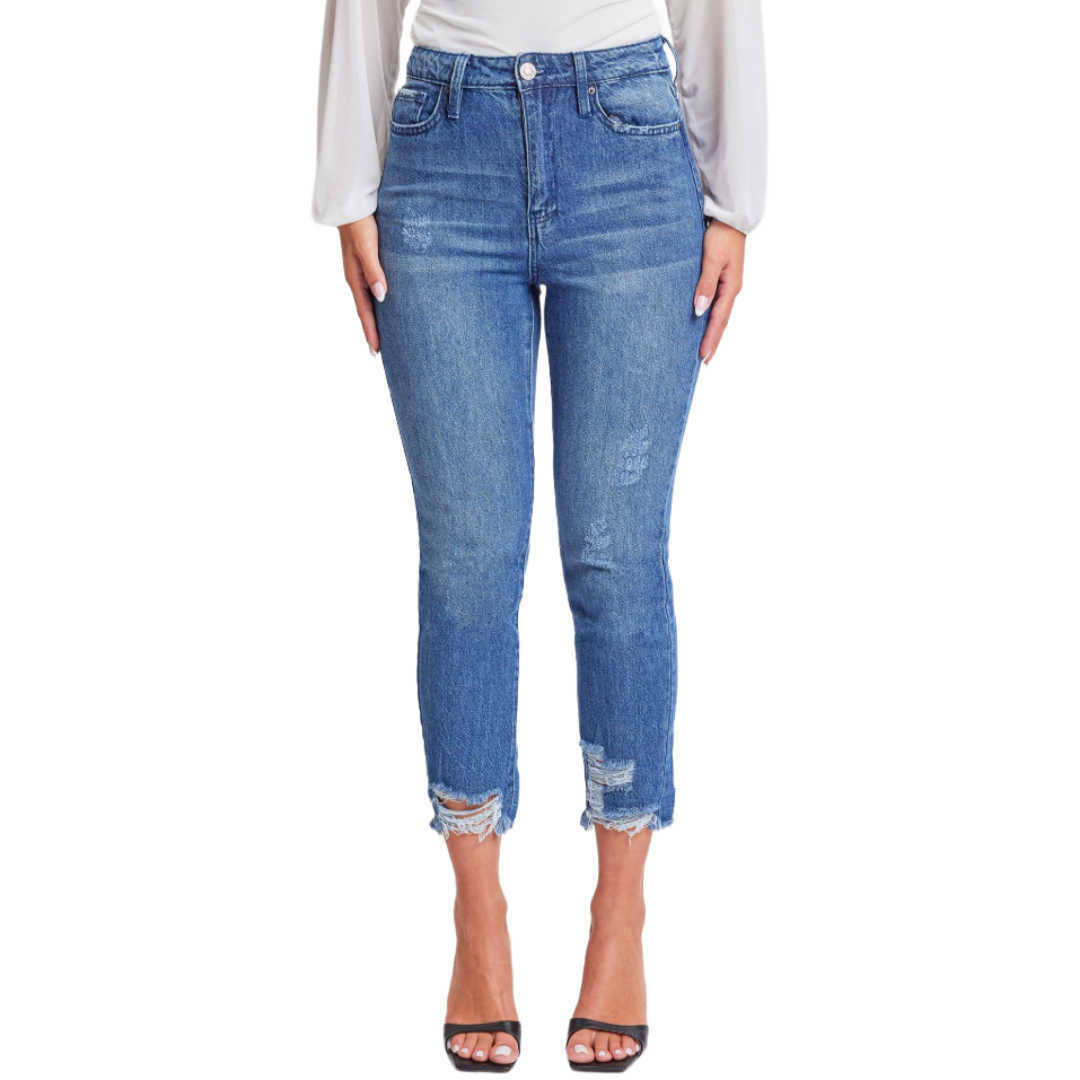 High-waisted blue skinny jeans with distressed detailing at the knees and hem, paired with black open-toed sandals.