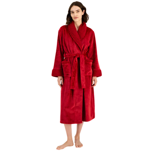 A woman is wearing a red, long-sleeved bathrobe with a textured shawl collar and cuffs, featuring front pockets and a tie belt.