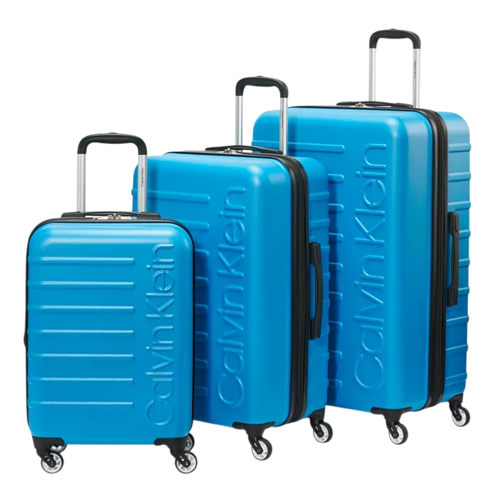 Bright blue Calvin Klein luggage set with three different sized suitcases, featuring hard shells, four wheels, and telescopic handles.