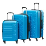 Bright blue Calvin Klein luggage set with three different sized suitcases, featuring hard shells, four wheels, and telescopic handles.