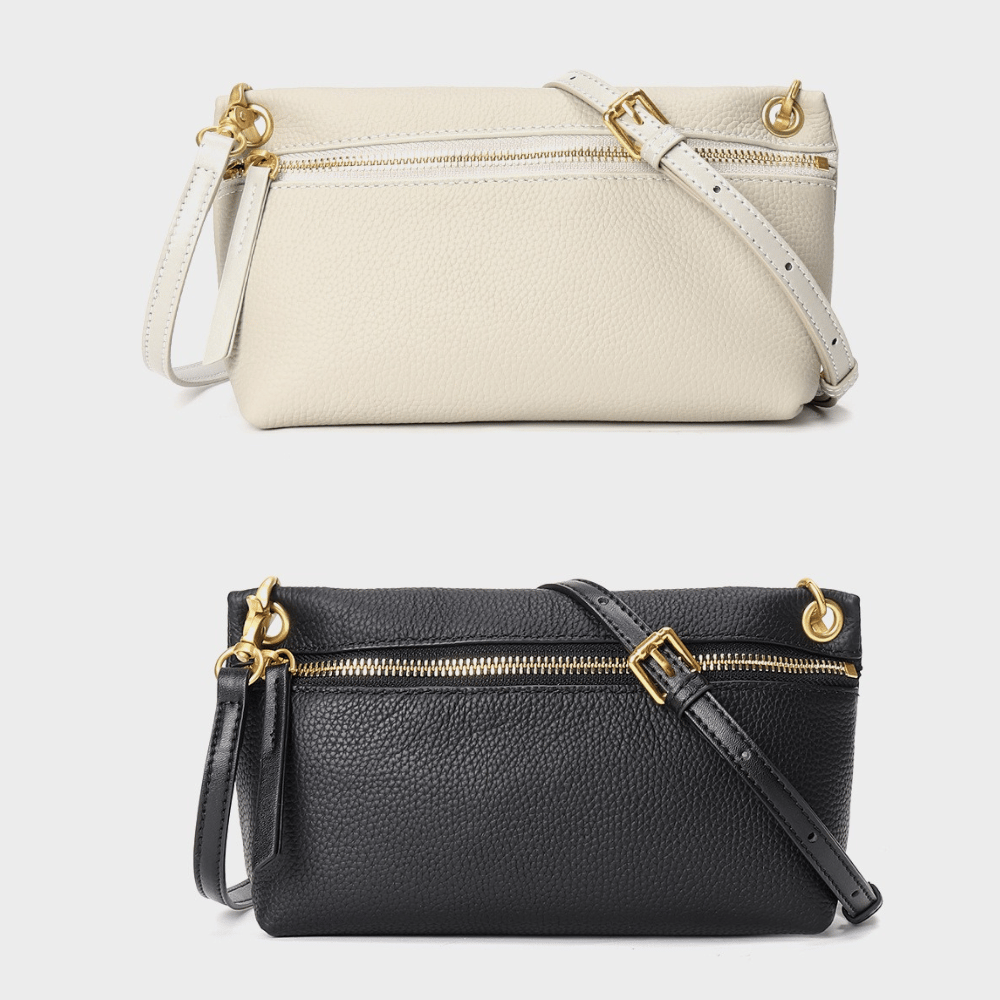 Two wristlet purses; one cream-colored and one black, both with gold-tone zippers and hardware.