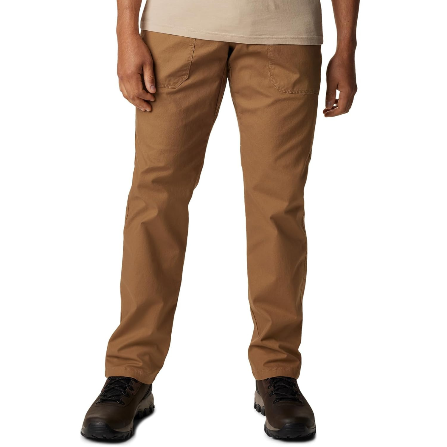 Columbia Men's Utility Pants are casual, brown pants with a straight fit and front patch pockets, paired with dark hiking boots. The pants offer a durable and functional design for everyday wear.