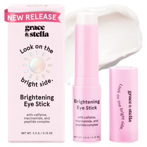 Grace & Stella Brightening Eye Stick with caffeine, niacinamide, and peptide complex. The packaging has a \“Look on the bright side\“ slogan and indicates a new release. Net weight: 3.5 g / 0.13 oz.