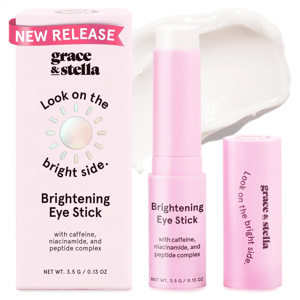 Grace & Stella Brightening Eye Stick with caffeine, niacinamide, and peptide complex. The packaging has a \“Look on the bright side\“ slogan and indicates a new release. Net weight: 3.5 g / 0.13 oz.