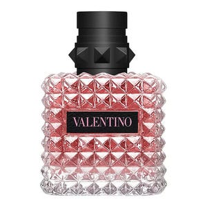 A pink glass bottle with a studded texture and a black cap, labeled \“Valentino.\“