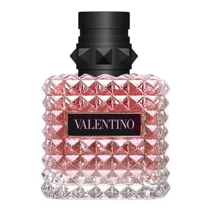 A pink glass bottle with a studded texture and a black cap, labeled \“Valentino.\“