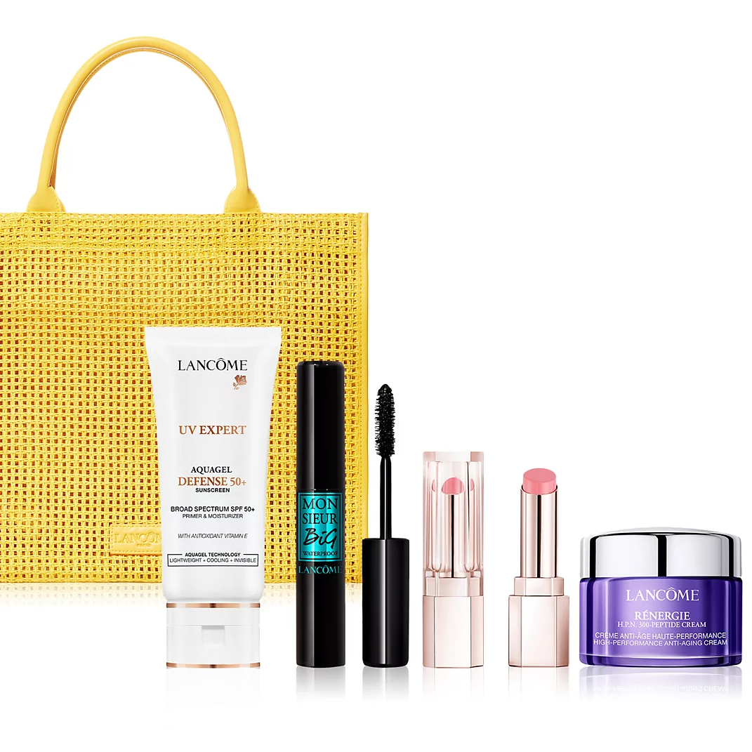 Yellow handbag with Lancôme products: UV Expert Aquagel Defense SPF 50+, Monsieur Big Mascara, lipstick, and Rénergie Multi-Peptide Cream.